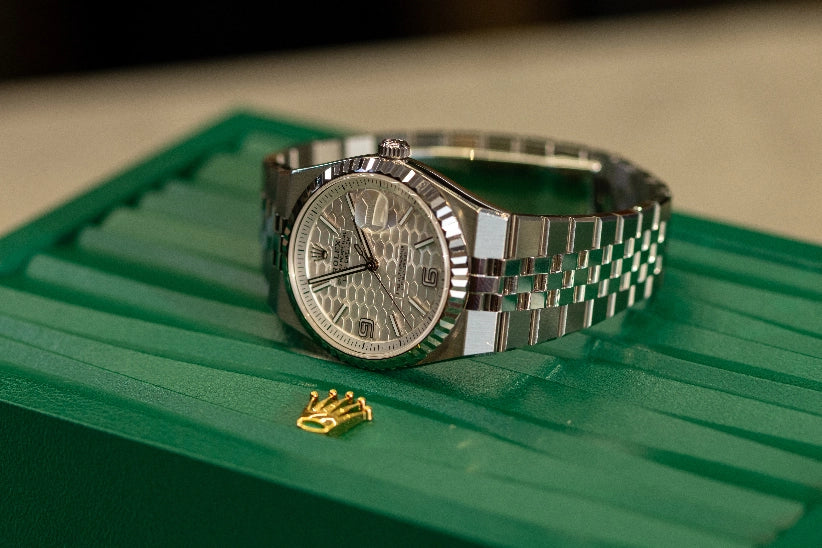 Rolex watch on green box